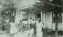 Landis family in front of homeplace
